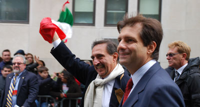 Ignazio La Russa, Italy's Minister of Defense, waving the Italian flag, and Francesco Talo, the Italian Consul in New York City.